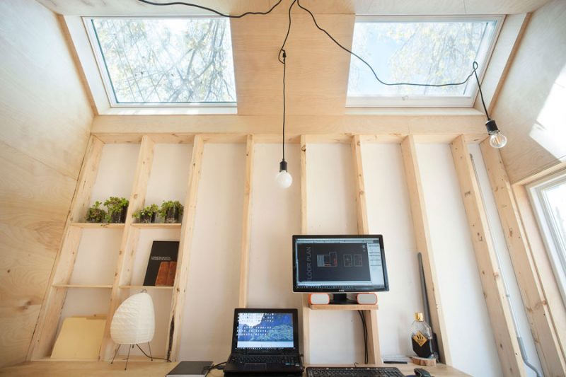 Architect heeft zijn kantoor ingericht in een houten tuinhuis van zijn tuin!