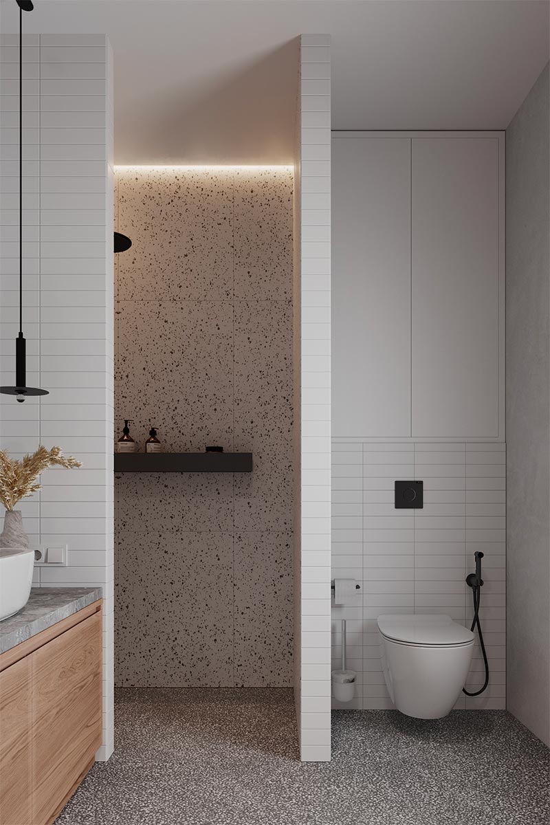 In dit moderne badkamerontwerp, gevisualiseerd door Alina Nykonets, is er gekozen voor een strakke zwarte rek van metaal, waar veel douchespullen in passen. 