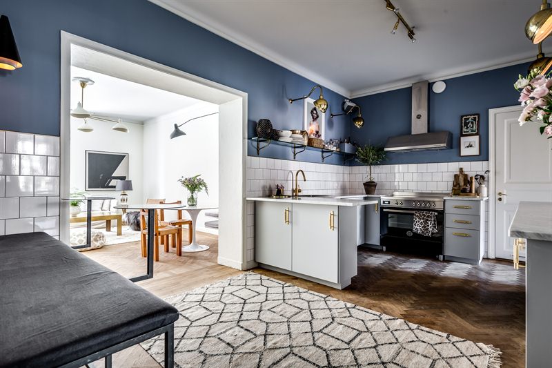 lichtgrijze schiereiland keuken marmeren werkblad gouden deurgrepen