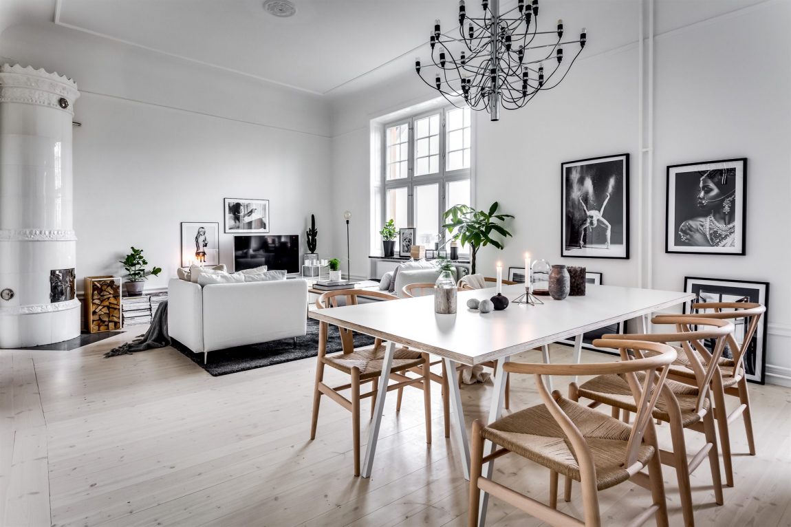 Deze Scandinavische eethoek is ingericht met een moderne witte eettafel met daaromheen de populaire Wishbone chairs. Klik hier voor meer foto's.